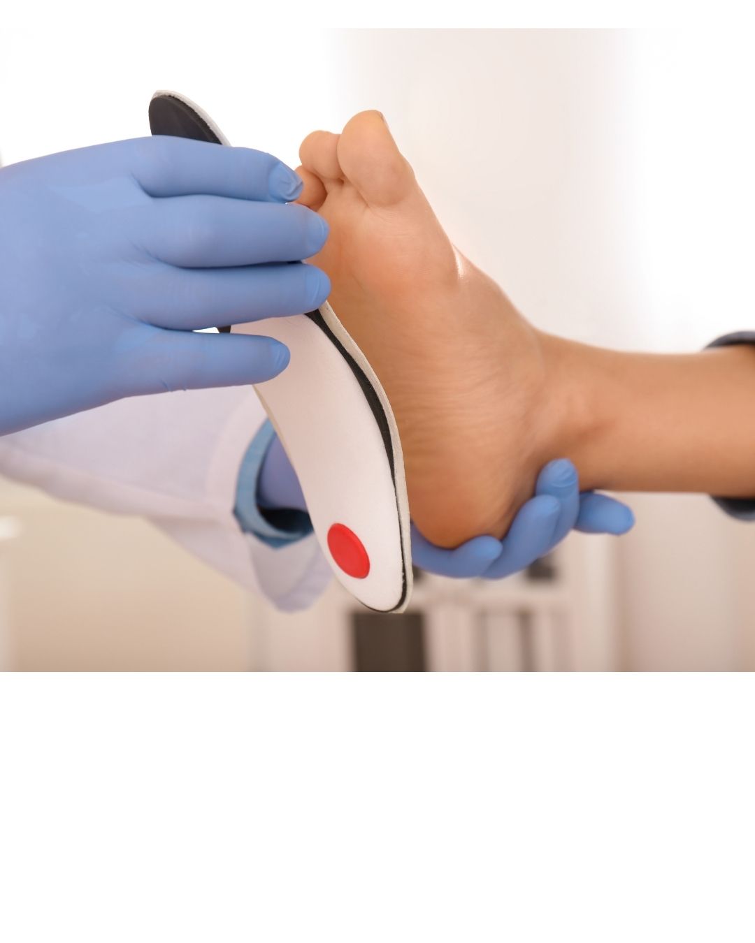 A clinician checking a custom foot orthotic against a patient’s foot